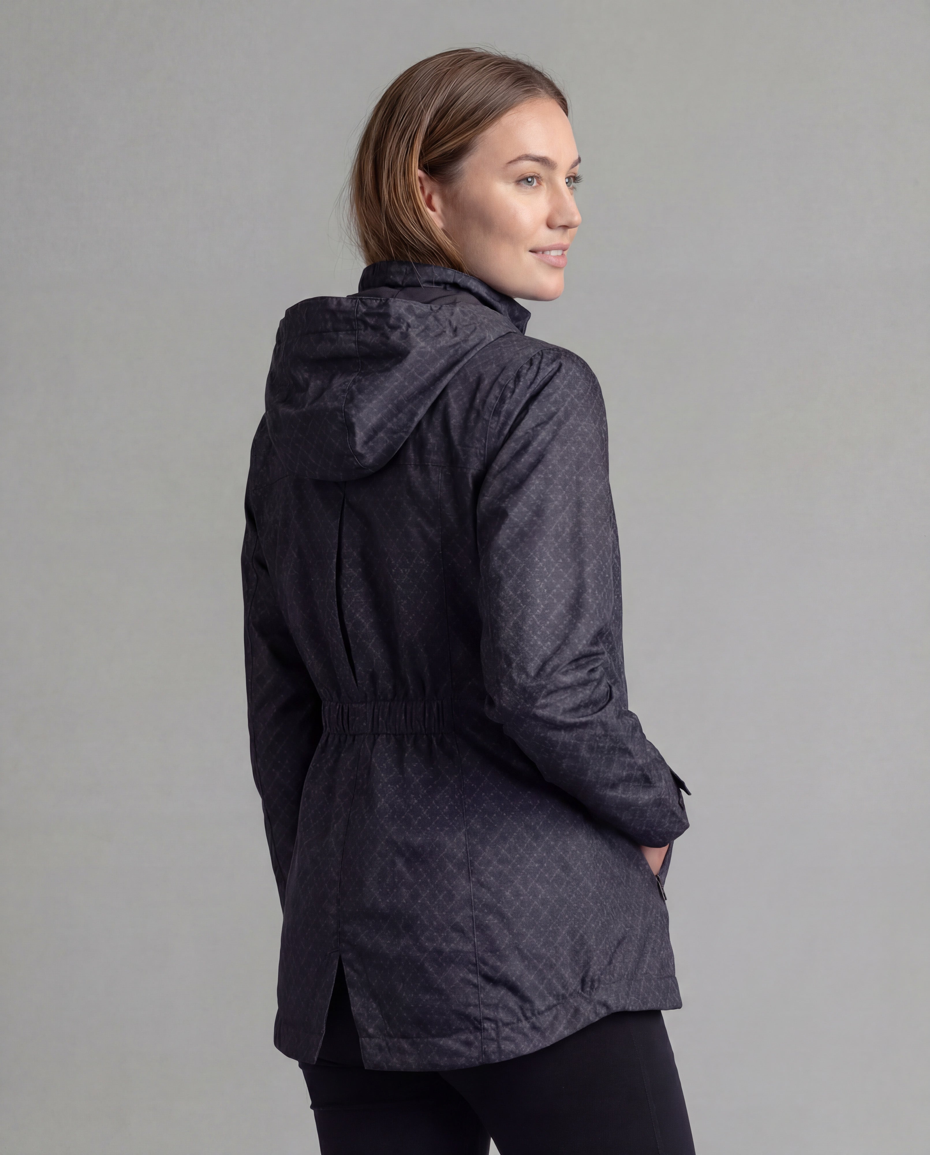 Black LIV Outdoor Women's Savannah fleece-lined rainshell jacket displayed from the back, showcasing its waterproof design and cozy fleece lining.