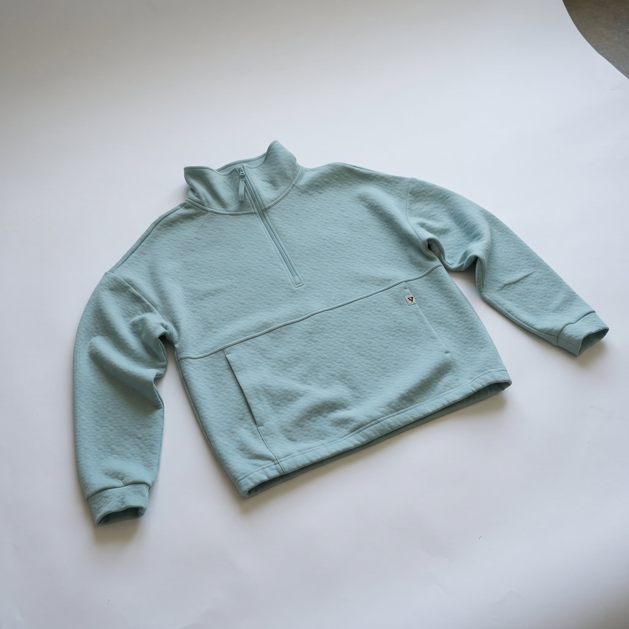 Women's LIV Outdoor Kaya quilted pullover in aqua grey, featuring a quarter-zip and cozy padded design.