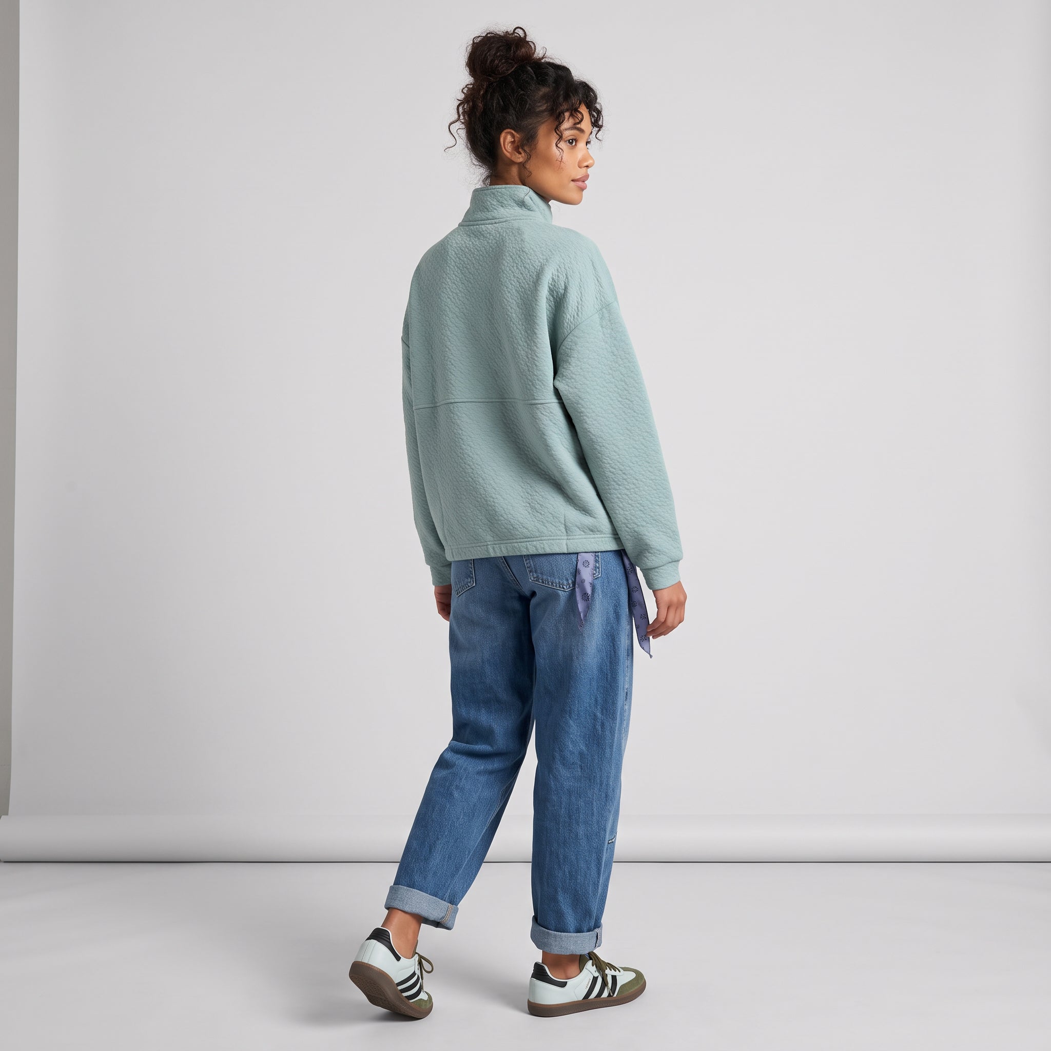 Women's LIV Outdoor Kaya quilted pullover in aqua grey, featuring a quarter-zip style, displayed on a neutral studio background.