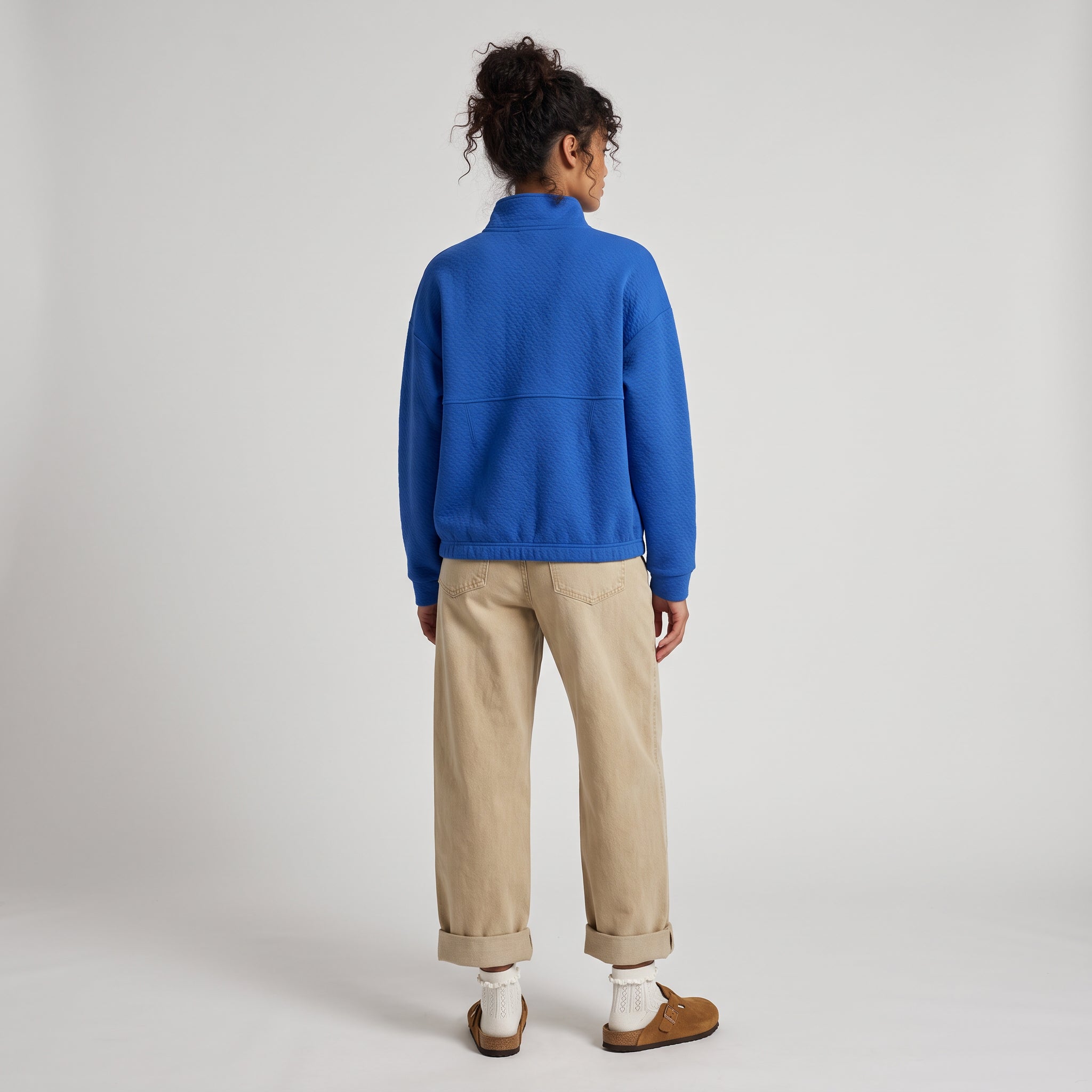 Women's LIV Outdoor Kaya quilted pullover in cerulean blue, shown with a quarter-zip design and cozy quilted fabric.