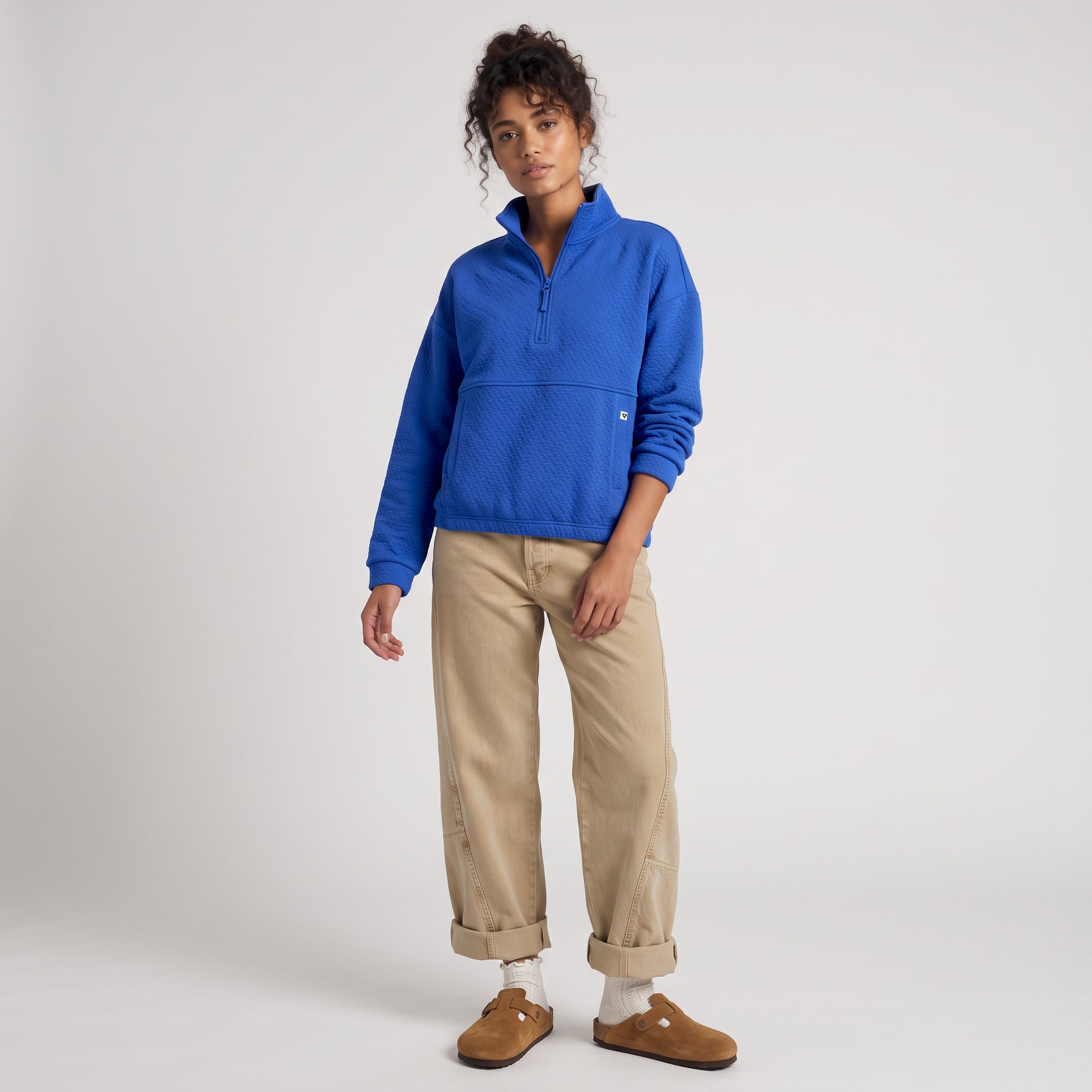 Women's LIV Outdoor Kaya quilted pullover in cerulean blue, featuring a quarter-zip and cozy quilted design.