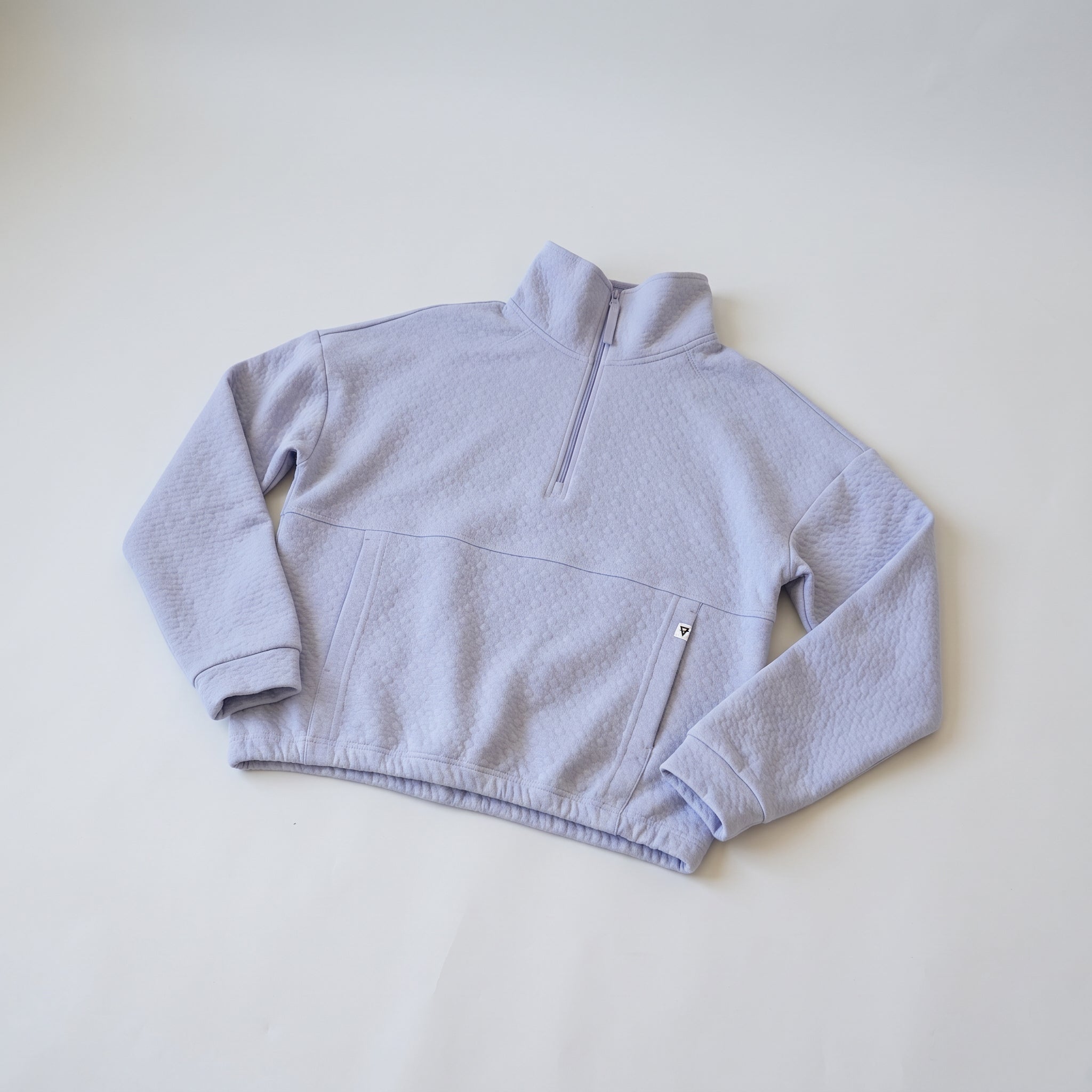 Women's LIV Outdoor Kaya quilted pullover with quarter-zip in Icelandic Blue, showcasing a cozy, stylish top for outdoor wear.