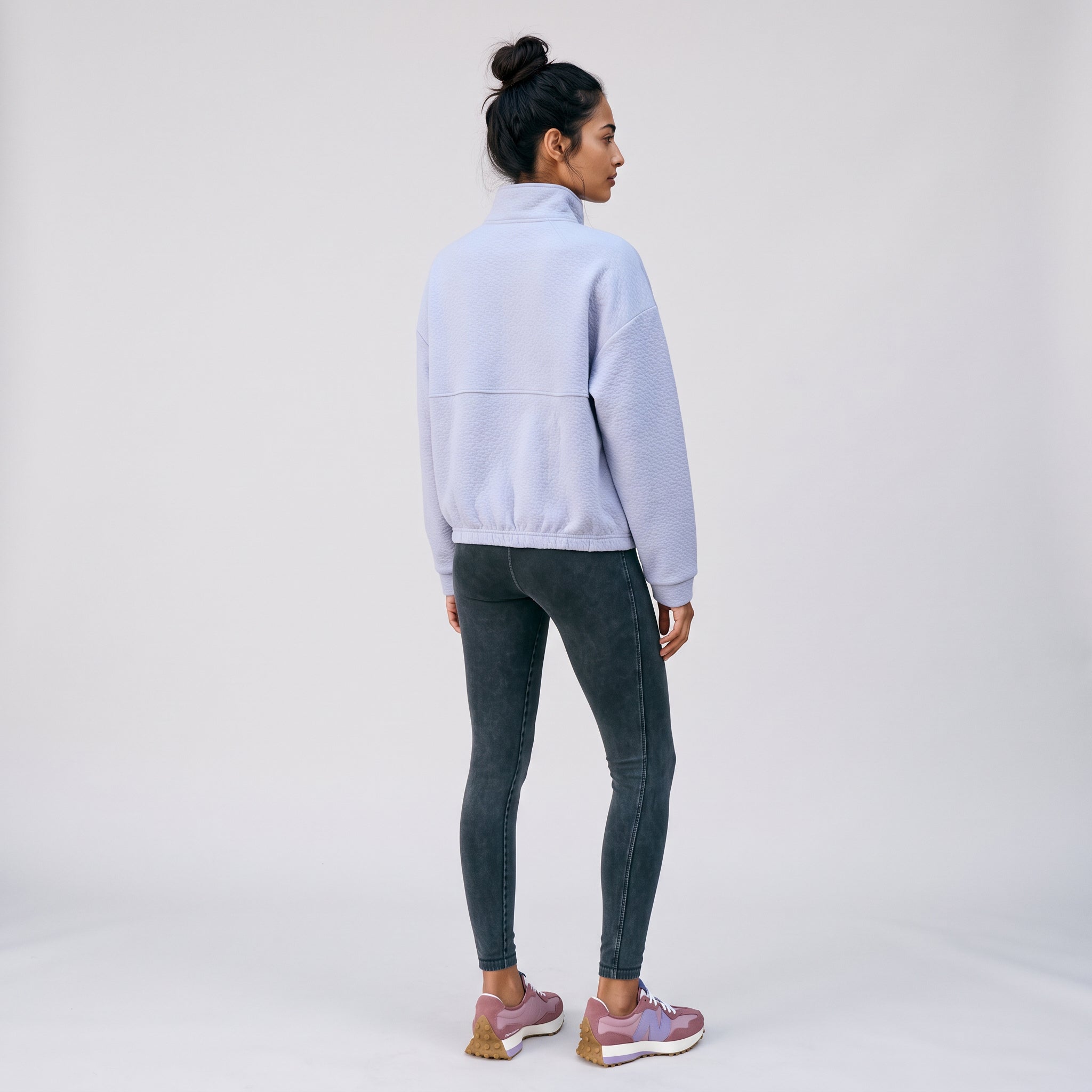 Women's LIV Outdoor Kaya quilted pullover in Icelandic Blue, featuring a quarter-zip design, displayed in studio setting.