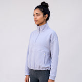 Women's LIV Outdoor Kaya quilted pullover in Icelandic Blue, featuring a quarter-zip and cozy quilted design.