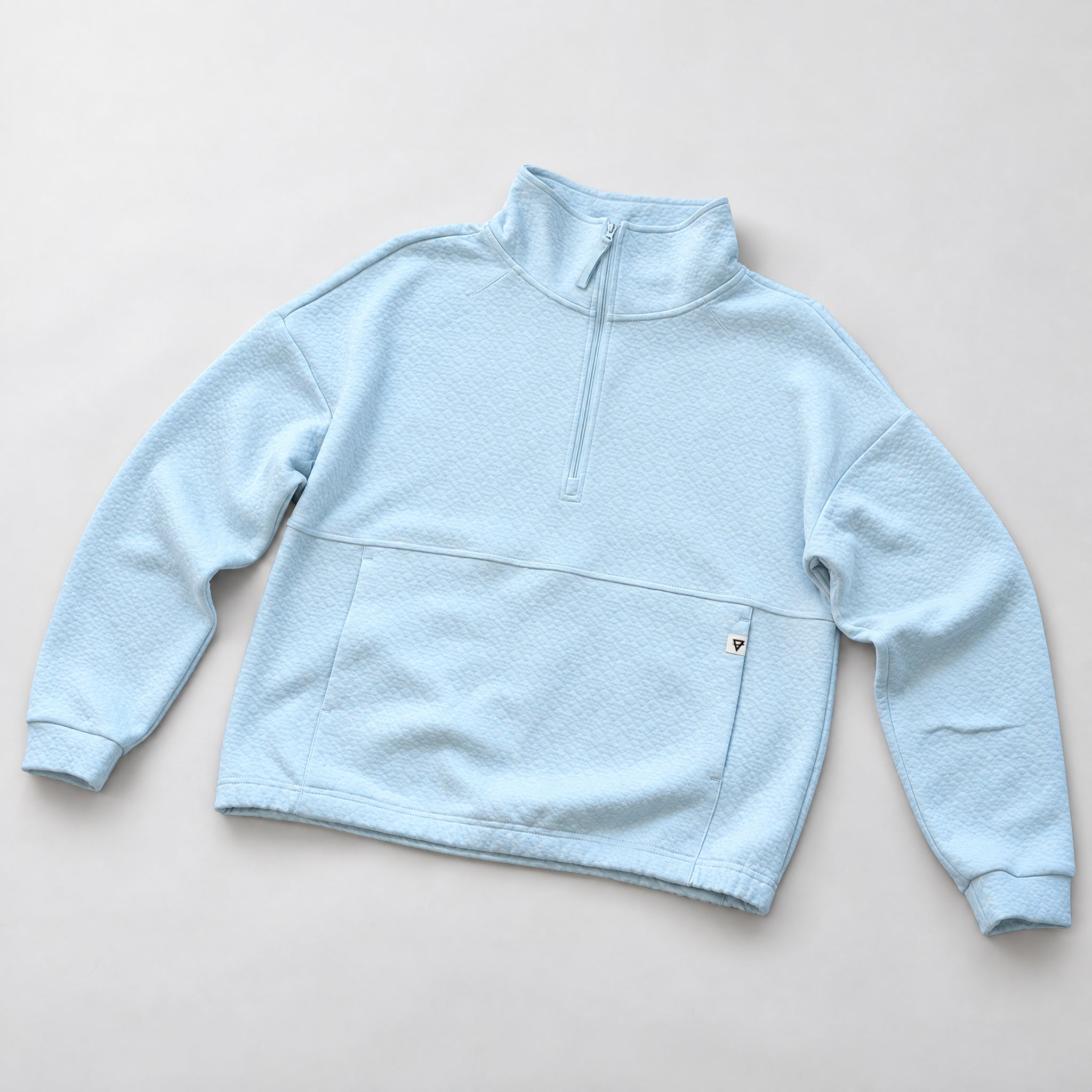 Women's LIV Outdoor Kaya quilted pullover in illusion blue, featuring a quarter-zip style and cozy quilted fabric.