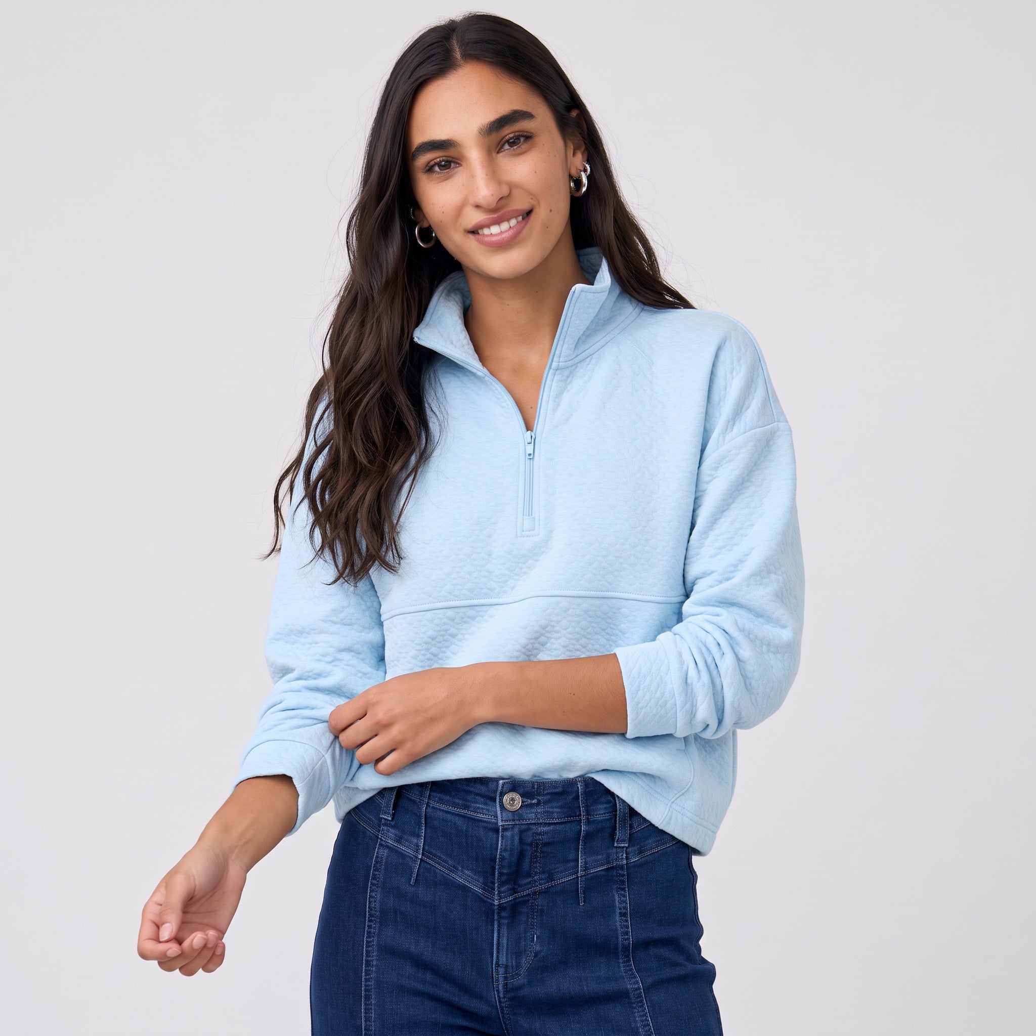Women's LIV Outdoor Kaya quilted pullover in illusion blue, featuring a quarter-zip and cozy quilted design, displayed on a model.