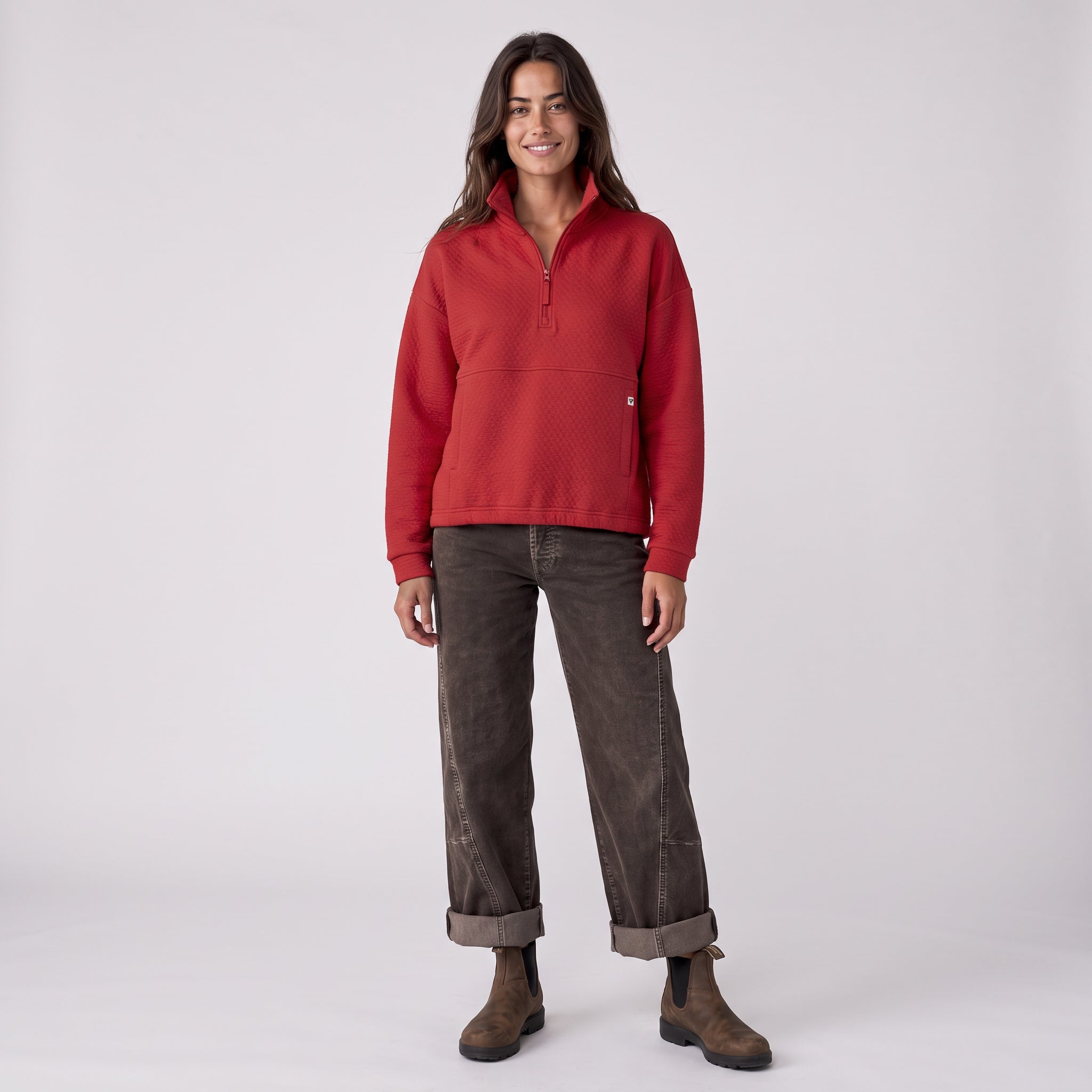 Women's LIV Outdoor Kaya quilted pullover with quarter zip in scarlet, shown on a model. Stylish women's top for outdoor wear.