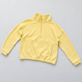 Women's LIV Outdoor Kaya quilted pullover with quarter-zip front, shown in a stylish sundress flat lay.