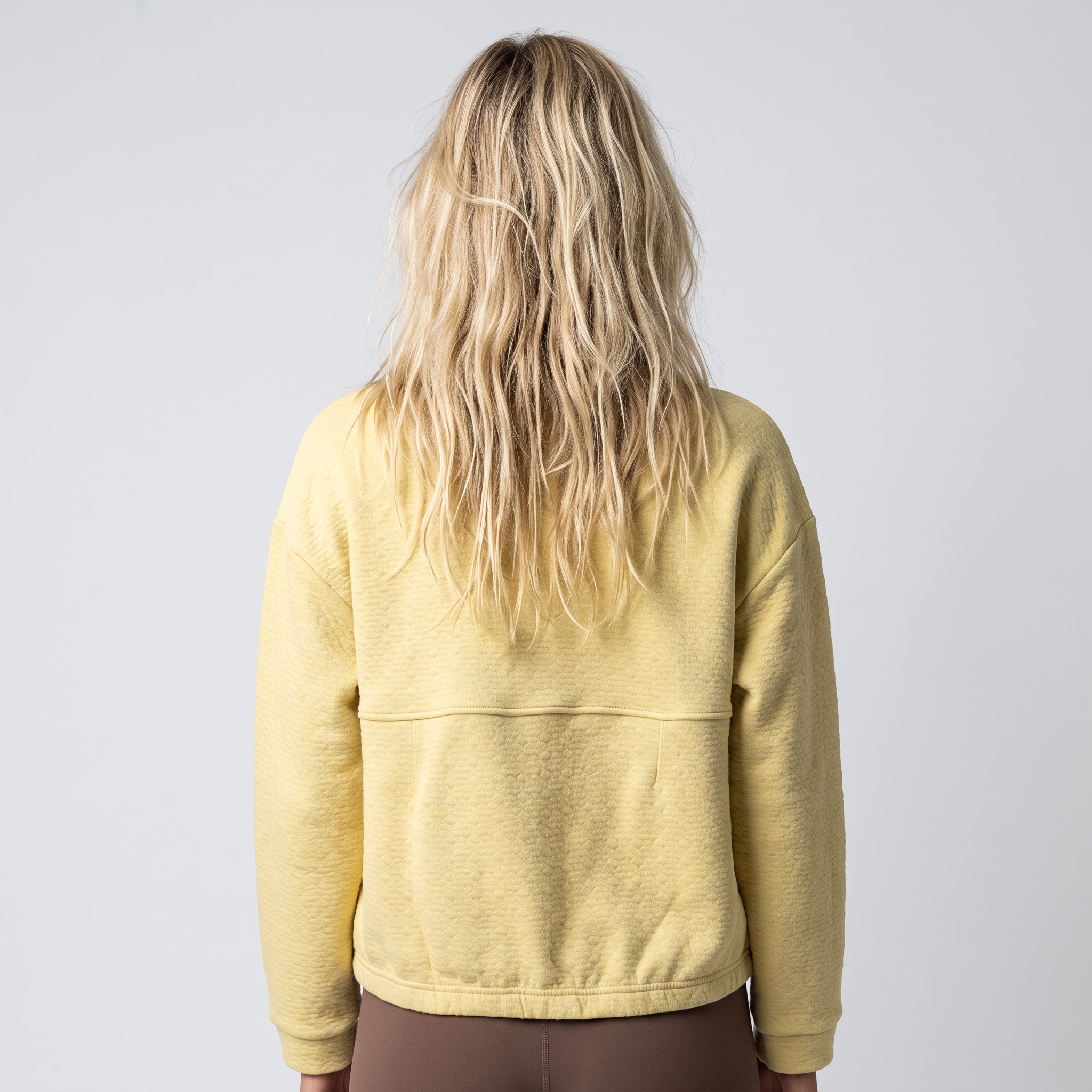 Women's LIV Outdoor Kaya quilted pullover with quarter-zip, shown in a stylish, cozy top on a light background.