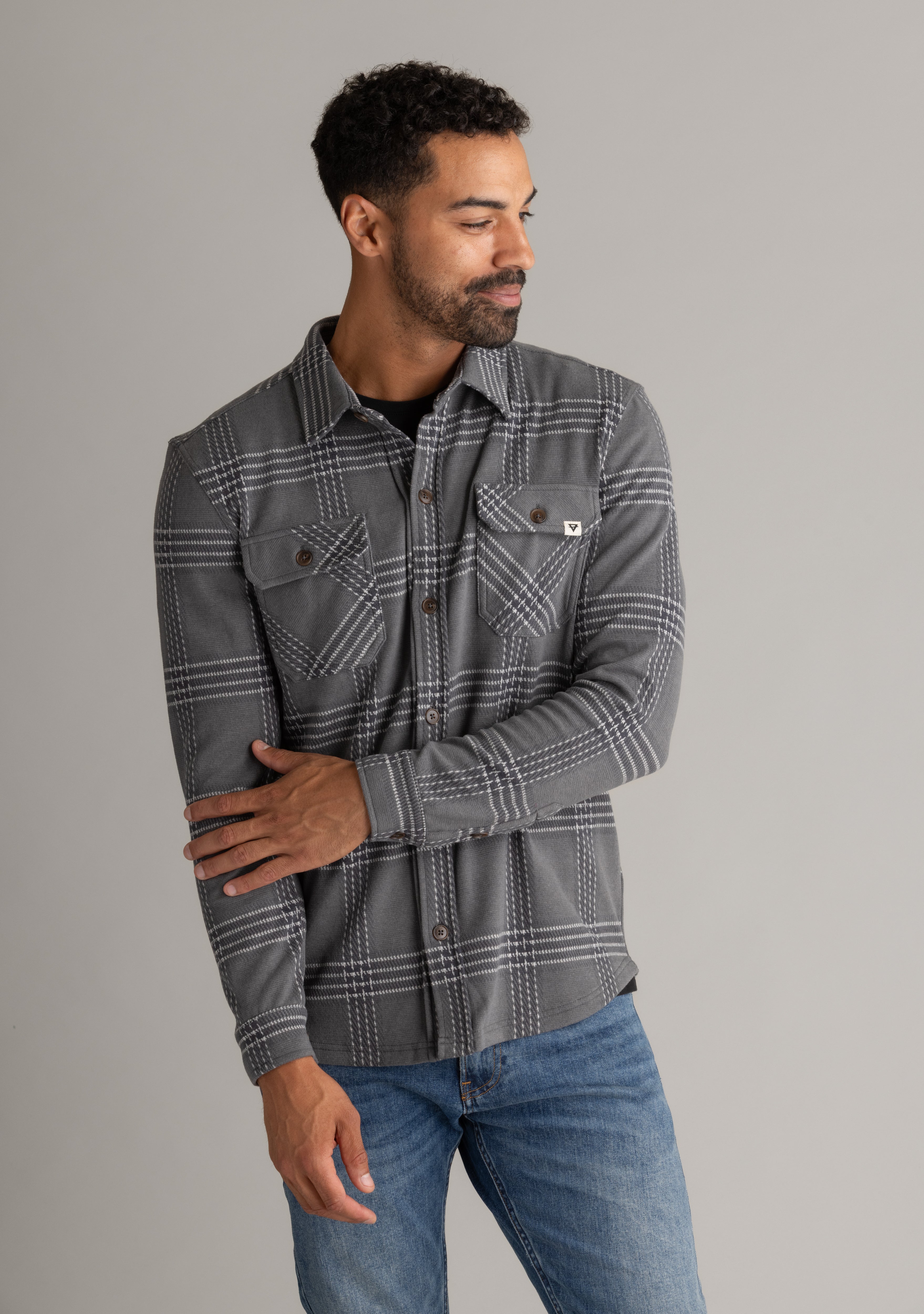 Men's LIV Outdoor Lichen Stretch Flannel Button Down shirt, featuring a plaid pattern and classic collar, displayed on a hanger.