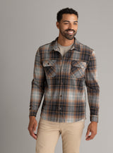 Men's LIV Outdoor Lichen Stretch Flannel button-down shirt in earthy tones, shown on a hanger.