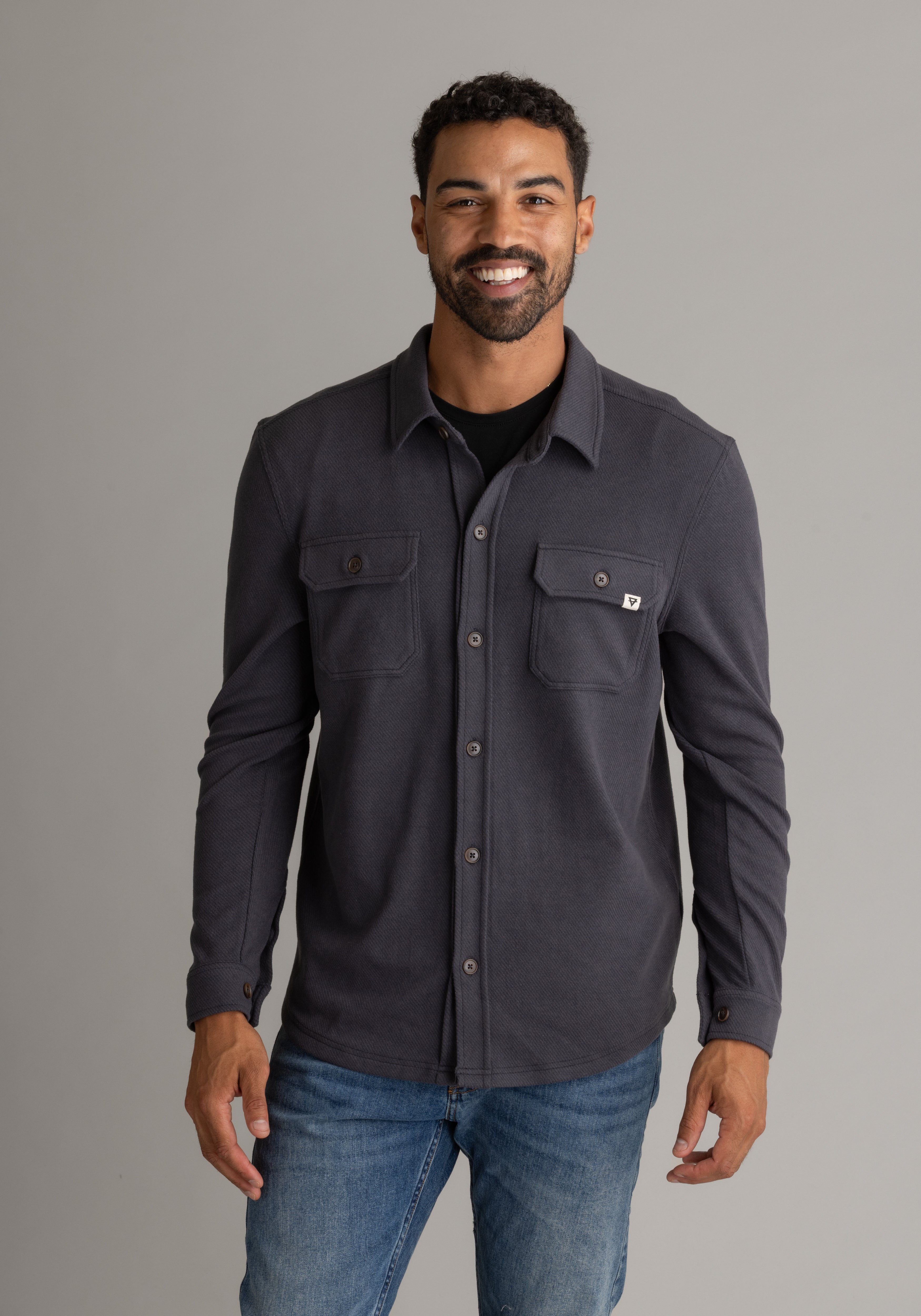 Men's LIV Outdoor lichen stretch flannel button-down top in black, featuring a classic plaid design and comfortable fit.
