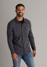 Men's LIV Outdoor Lichen Stretch Flannel Button Down shirt in black, featuring a classic plaid pattern and button-front design.
