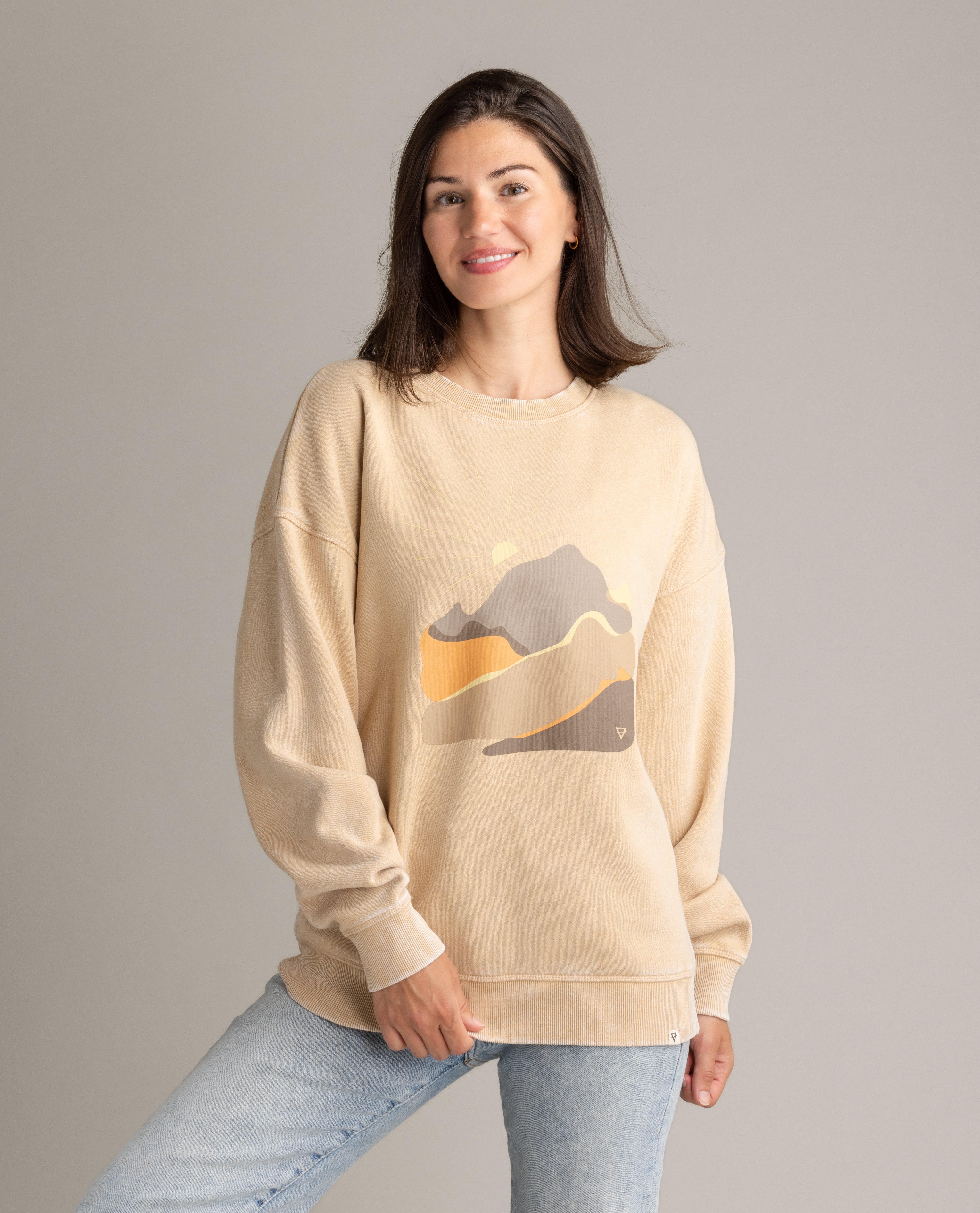 LIV Outdoor women's oversized graphic crew sweatshirt in stonewashed with abstract landscape design.